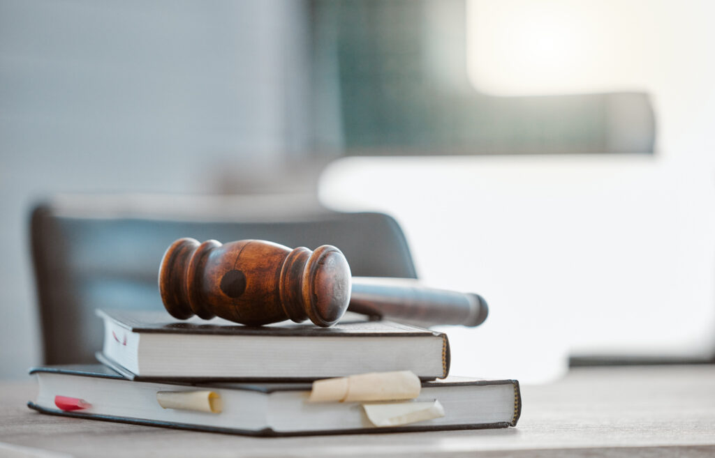 Justice, gavel and law books on table in office for court trial, legislation or fair constitution by judicial system.