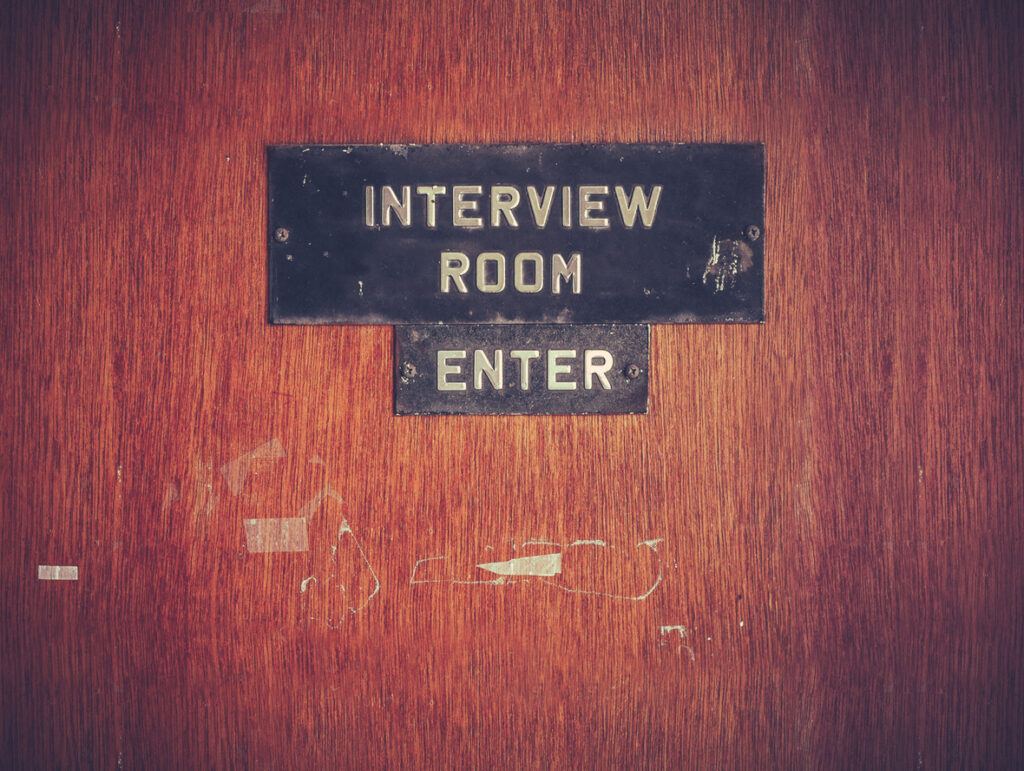 Wooden Interview Room Door with interview room and enter signs on the door